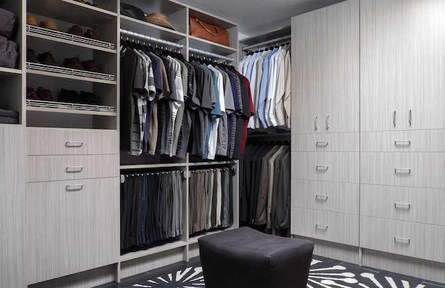 Clutter free closet with flat panel cabinets and clothes hanger solutions