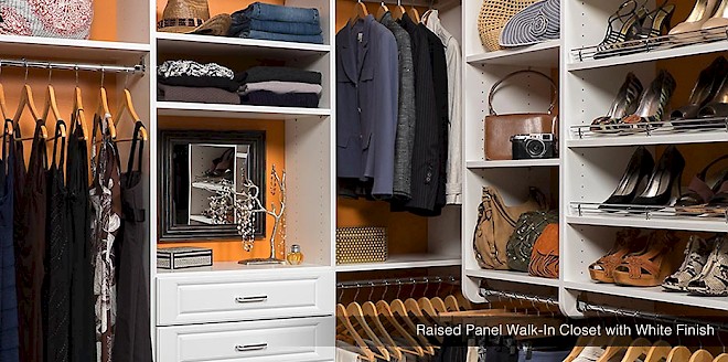 An organized closet with cabinets and accessory organization solutions